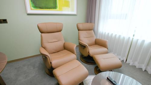 a waiting room with two chairs and a table at Grabel Hotel Jeju in Jeju