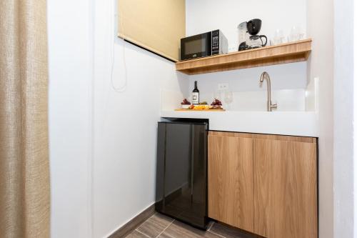 a kitchen with a sink and a microwave at Barcelo Coliving in Medellín