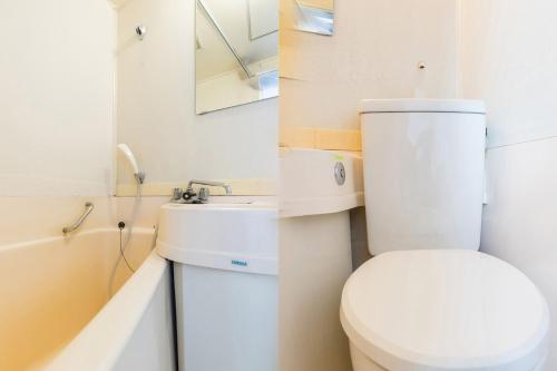 two pictures of a bathroom with a toilet and a sink at Tabist Business Hotel Kanazono Gifu in Gifu
