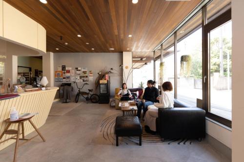 a group of people sitting in a living room at tune HIGORO in Tateyama