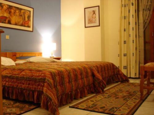 a bedroom with a bed with a orange blanket at Sun View Guesthouse in Delphi