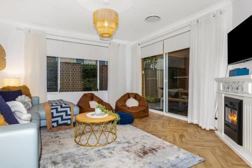 a living room with a couch and a fireplace at Town Central, walk to the beach in Busselton