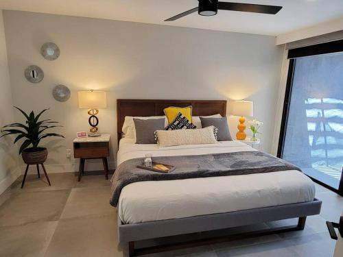a bedroom with a large bed and a window at Upscale mid century on the green w Private Hot Tub in Palm Desert