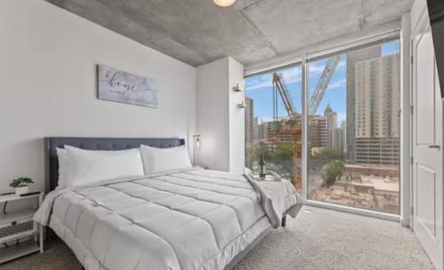 a bedroom with a large bed and a large window at Atlanta Midtown High-Rise Condo With King Bed Free Parking and Balcony With View in Atlanta