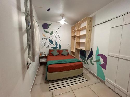 a small bedroom with a bed in a room at Guest House Vida Vibra in Ubatuba
