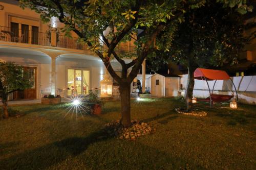 a house with a tree in the yard at night at Florence Comfort B&B in Florence