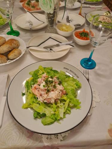 a table with a plate of salad on it at Tribal house in Río Seco