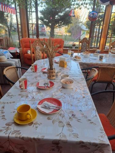 a table with plates and dishes on it with a table cloth at Tribal house in Río Seco