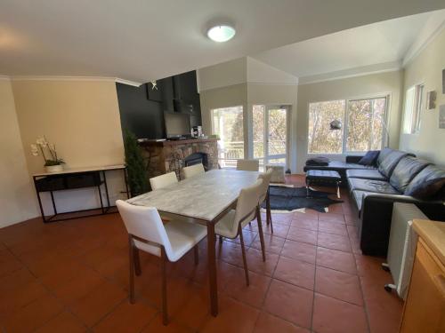 a living room with a table and a couch at Inala 3 - Thredbo in Thredbo