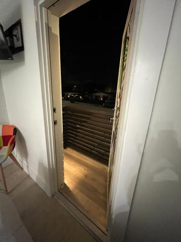 a door with a view of a balcony at night at Luna y Sol Calle 8 in Miami