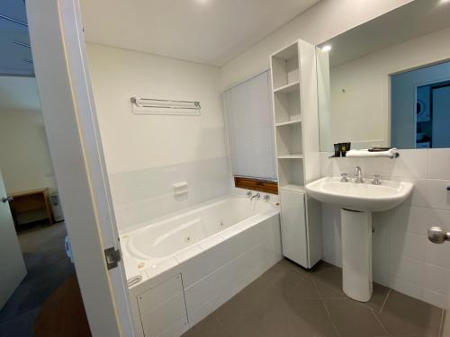 a bathroom with a sink and a bath tub and a sink at Ramshead Creek 3 - Thredbo in Thredbo