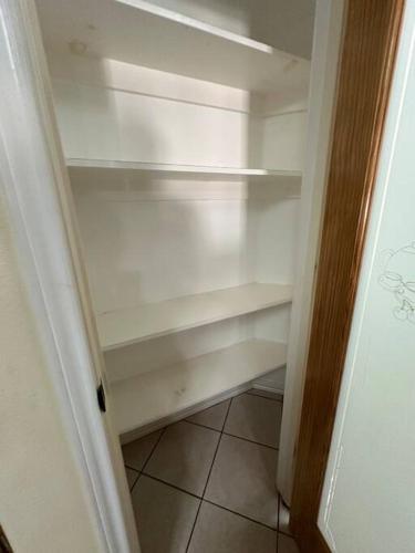 a white refrigerator with its door open in a room at Casa Colibrí in Harlingen