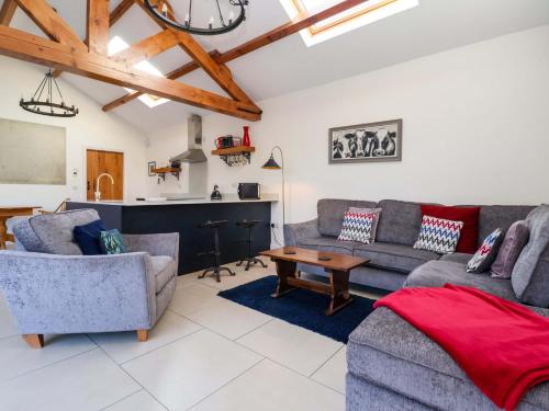 a living room with two couches and a table at Kingfisher Corner in Great Driffield