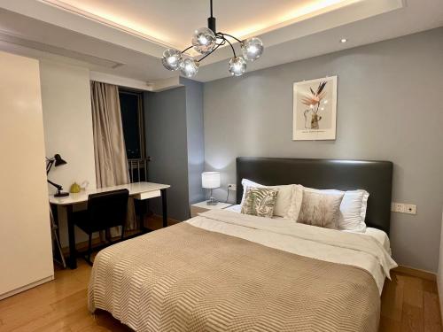 a bedroom with a bed and a desk and a table at Shanghai Lerongju Boutique Apartment Metro Line 8 20meter in Shanghai