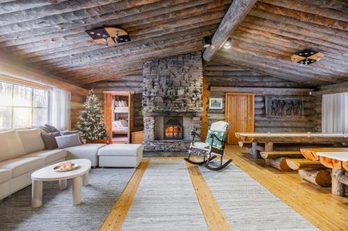 a living room with a couch and a fireplace at The Haven of Riverside - Villa Sieripirtti in Rovaniemi