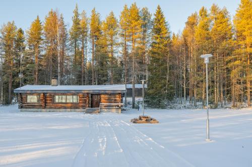 a log cabin in the snow with trees at The Haven of Riverside - Villa Sieripirtti in Rovaniemi