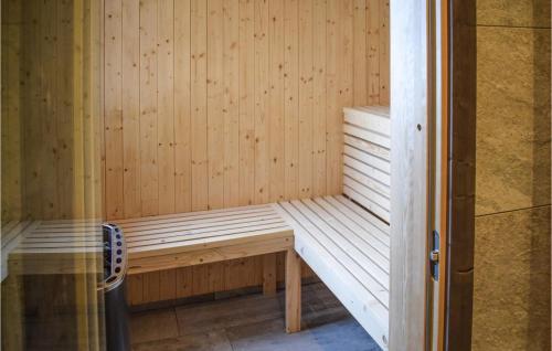 a wooden sauna with a wooden bench in it at Awesome Home In Rauland With Sauna in Rauland