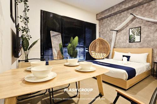 a bedroom with a bed and a wooden table with cups at Forte Seasons Mossaz Premium Suites Petaling Jaya in Petaling Jaya