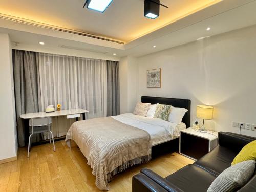 a bedroom with a bed and a couch at Shanghai Lerongju Boutique Apartment Metro Line 8 20meter in Shanghai