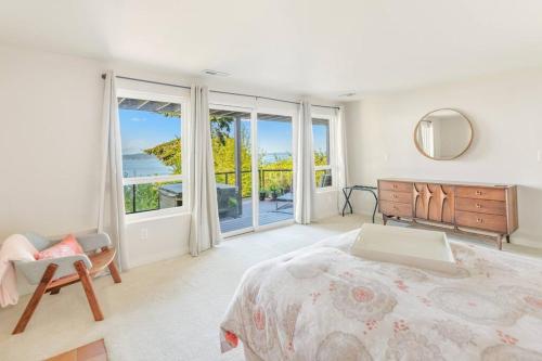 a bedroom with a bed and a large window at Quintessential Seattle Water Views w HotTub in Seattle