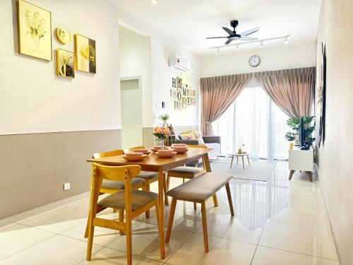 a dining room and living room with a table and chairs at Decozy 9 Ipoh Town Condo 12pax in Ipoh