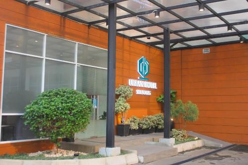 a sign on the side of a building at Urban Hotel Serpong in Banten