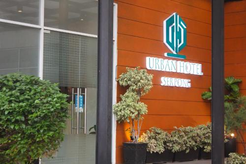 a sign for an urban hotel in front of a building at Urban Hotel Serpong in Banten