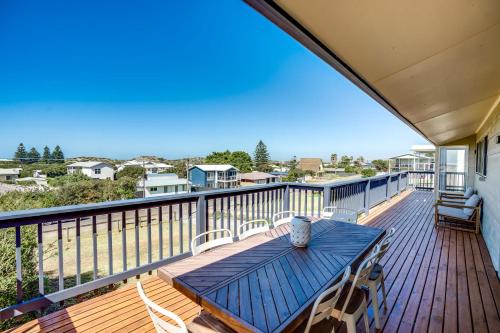 a wooden deck with a blue table and chairs on it at The Beach House 64 Neighbour Ave Goolwa Beach - No Linen Included in Goolwa