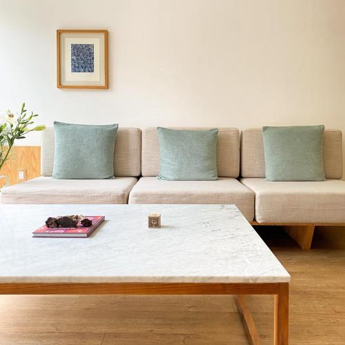 a living room with a couch and a table at Reforma Guest House in Mexico City