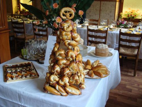 a table topped with a tower of bread and food at Logis Hôtel Restaurant La Tête Des Faux in Le Bonhomme