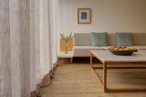 a living room with a couch and a bowl of fruit on a table at Reforma Guest House in Mexico City