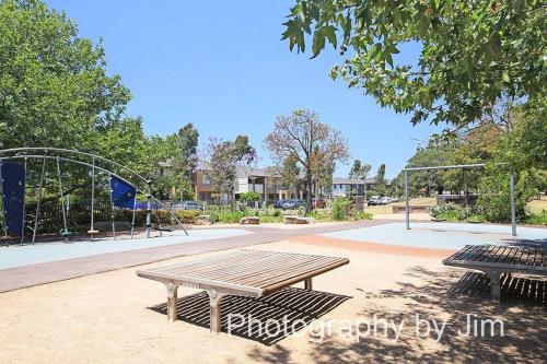 a park with a picnic table and a playground at Sydney Lidcombe, Super Comfort, Stylish, large 2bedrooms, 2 bath, 2 free carpark, Parkview, Free Wifi in Sydney