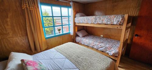 Postel nebo postele na pokoji v ubytování Hostal Castro Chiloé - Chacabuco #279