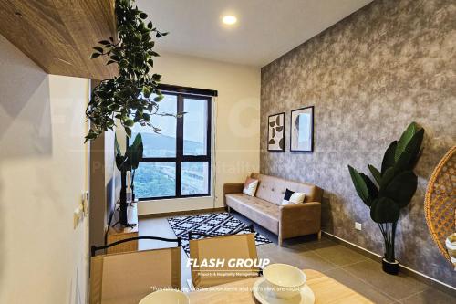 a living room with a couch and a window at Forte Seasons Mossaz Premium Suites Petaling Jaya in Petaling Jaya