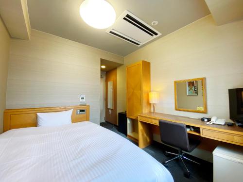 Ένα ή περισσότερα κρεβάτια σε δωμάτιο στο Hotel Route-Inn Shin-Shirakawa Eki Higashi