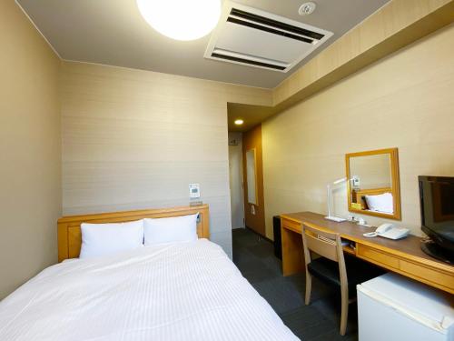 Ένα ή περισσότερα κρεβάτια σε δωμάτιο στο Hotel Route-Inn Shin-Shirakawa Eki Higashi
