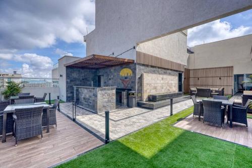 a patio with tables and chairs and a fireplace at Elite Residence 7 Star Luxe Condo with Gym and Pool next to JW Marriott, Westlands Airport Shuttle, Luggage Storage available in Nairobi