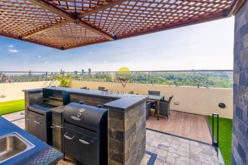 an outdoor kitchen with a view of the beach at Elite Residence 7 Star Luxe Condo with Gym and Pool next to JW Marriott, Westlands Airport Shuttle, Luggage Storage available in Nairobi