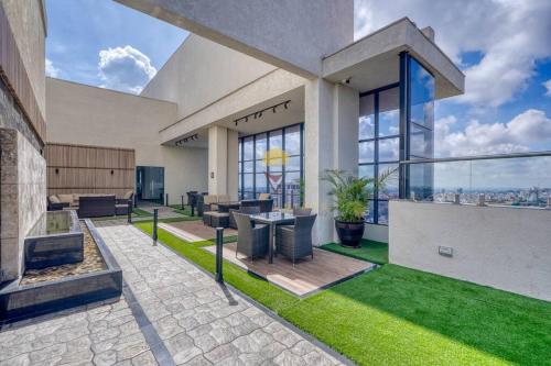 a house with a patio with green grass at Elite Residence 7 Star Luxe Condo with Gym and Pool next to JW Marriott, Westlands Airport Shuttle, Luggage Storage available in Nairobi