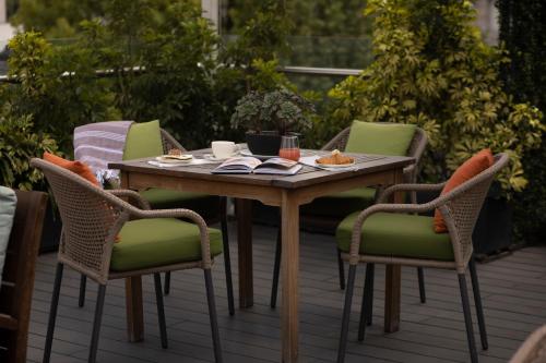 a wooden table and chairs on a patio at Reforma Guest House in Mexico City