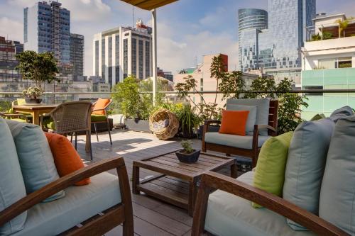 a rooftop patio with furniture and a view of the city at Reforma Guest House in Mexico City