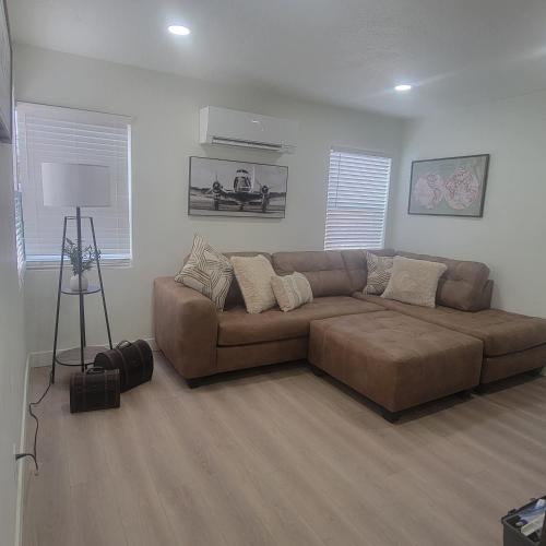 a living room with a brown couch in a room at Cozy Cottage near USU in Logan