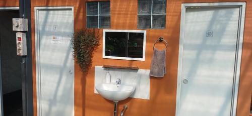 a bathroom with a sink and a window at Dewi Sri Guesthouse in Mataram
