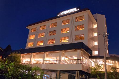 a building with a sign on top of it at night at Hotel&Resort Yamanouchi Hills in Yamanouchi
