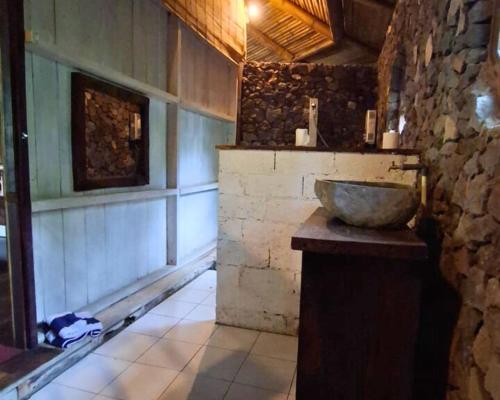 a bathroom with a bowl sink on a counter at Warung Rekreasi Bedugul in Bedugul