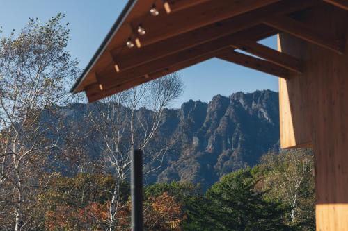 a view of the mountains from a wooden building at Earthboat Togakushi in Nagano