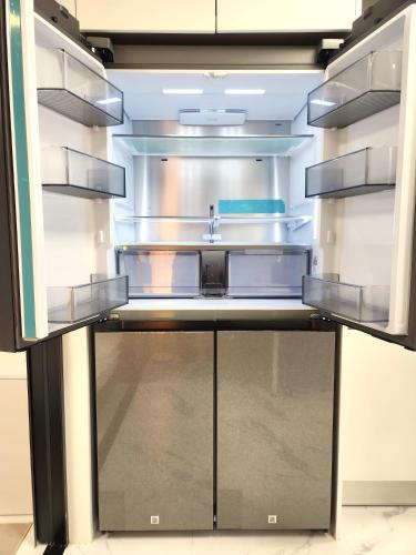 a refrigerator with its door open with a sink at Majestic Seoul Stay Central in Seoul