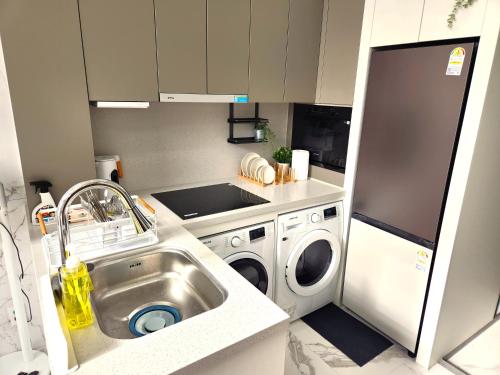 a kitchen with a sink and a washing machine at Majestic Seoul Stay Central in Seoul