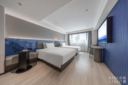 Postel nebo postele na pokoji v ubytování Atour Light Hotel Kunming Dongfeng Plaza Beijing Road