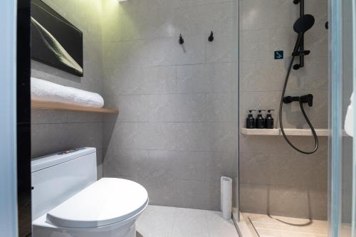 a bathroom with a shower and a toilet at Atour Hotel Chengdu Sichuan Normal University in Chengdu